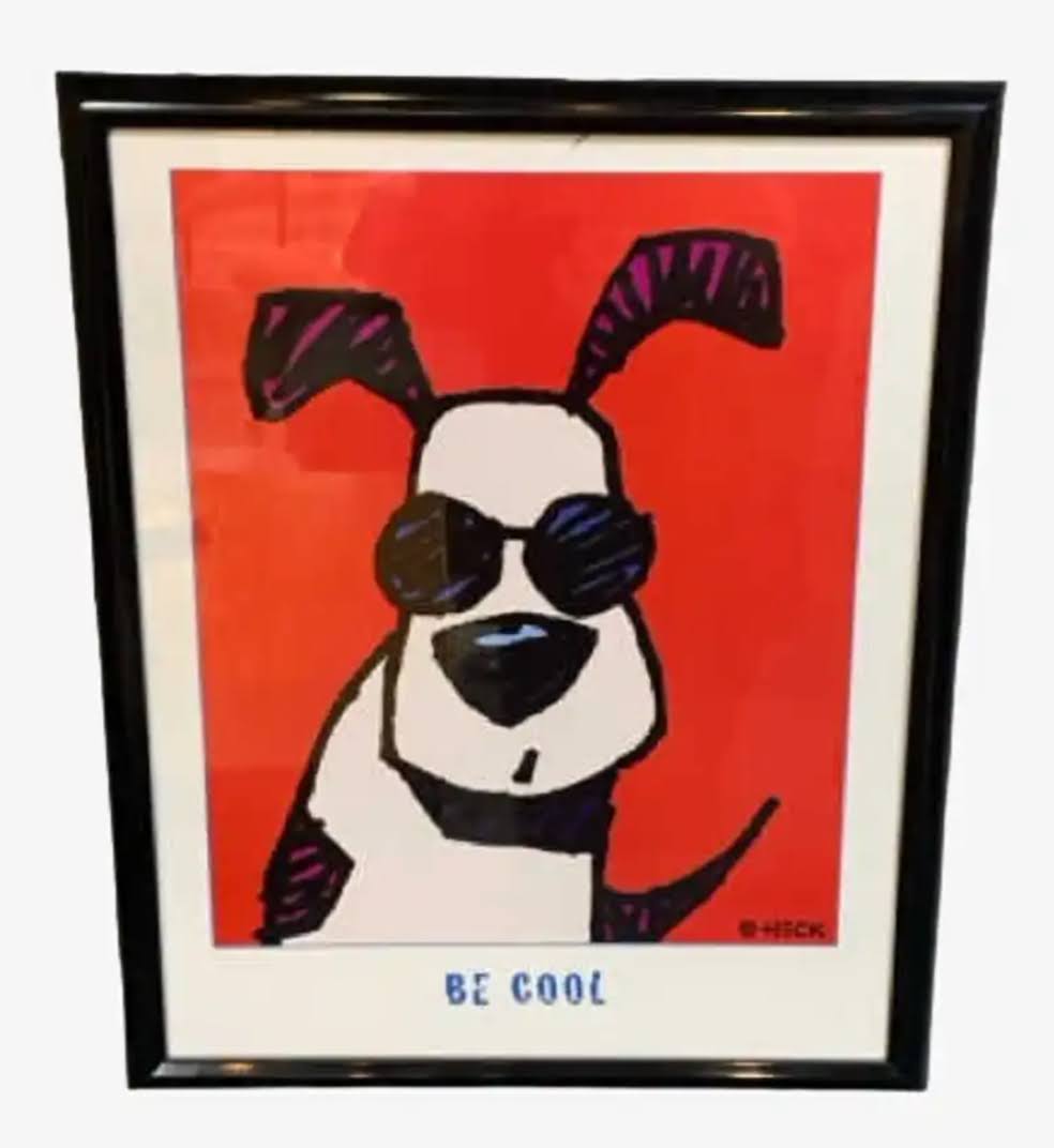 A framed poster with a cartoon illustration of a dog wearing sunglasses. Text below the picture reads, 'BE COOL.'